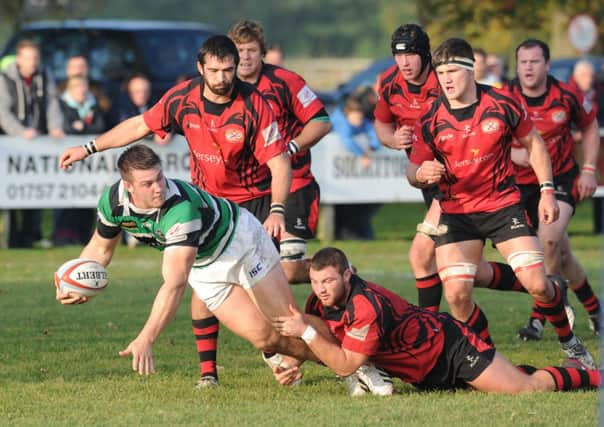 Ben Harris looks to release the ball for Leeds.