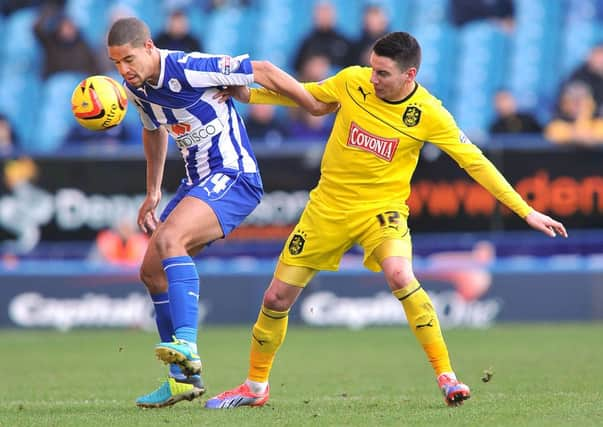 Huddersfield Town's Adam Hammill battles with Sheffield Wednesday's Giles Coke.