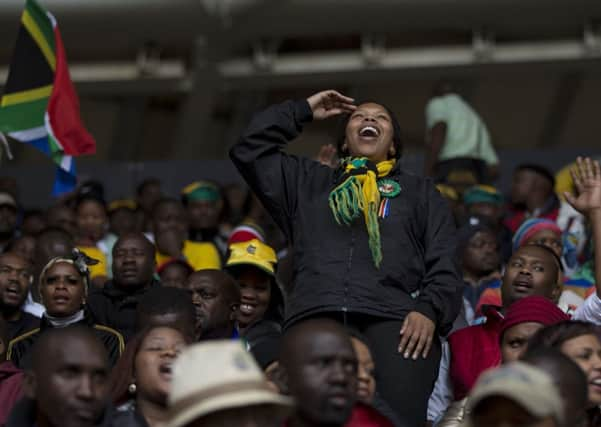 VIP's and dignitaries stand up for the start of the memorial service for former South African president Nelson Mandela