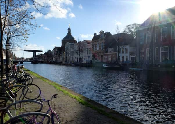 The low autumn sun shines over the canals of Leiden, Holland