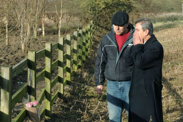 Ali Aydi (right), uncle of  murdered mum Rania Alayed, lays flowers in a layby alongside the A19 near Thirsk