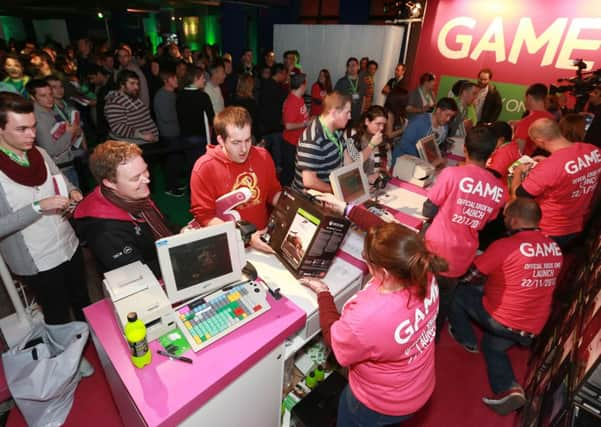 Game customers queue to pick up an Xbox One