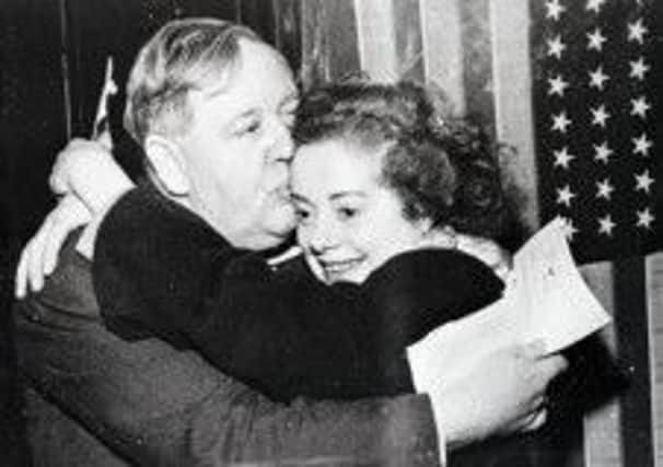 Actor Charles Laughton and his actress wife, Elsa Lanchester and Robert Mitchum in The Night of the Hunter, below.