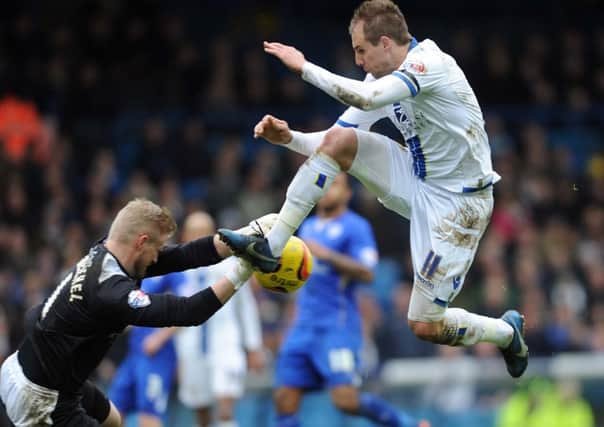 Kasper Schmeichel blocks the ball from Luke Varney