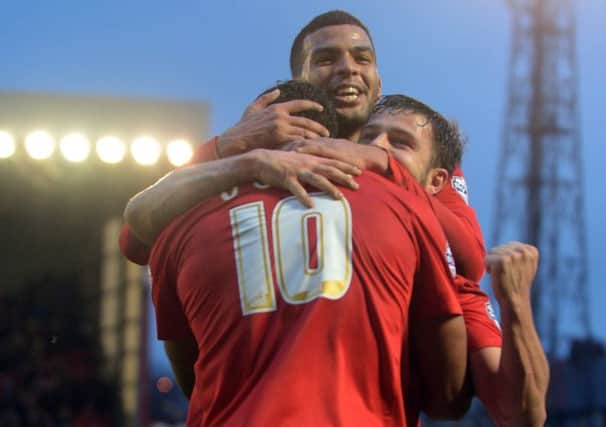 Dale Jennings and Jacob Mellis congratulate Chris O'Grady