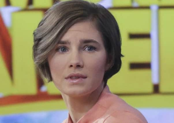 Amanda Knox prepares to leave the set following a television interview in New York