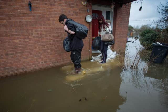 Home owner Louise Barnett and her friend Elliot Outram move belongs from her house in Moorland, Somerset