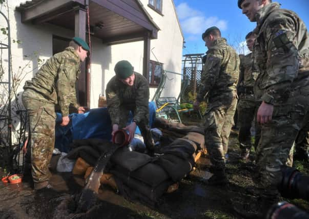 Emergency workers in Moorland, Somerset, after residents were advised to evacuate after flood defences were breached overnight.