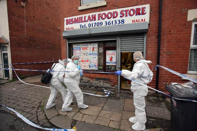 Police forensic officers inside the Bismillah Food Store in Rotherham