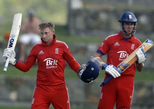 England's Joe Root, left, celebrates after he scored a century next to team's captain Stuart Broad.