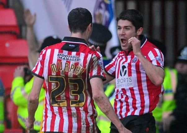 Sheffield United's scorer of the match Ryan Flynn celebrates towards Jamie Murphy.