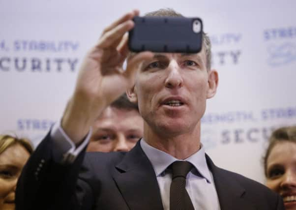 Shadow International Development Secretary Jim Murphy takes a selfie as part of a TV interview