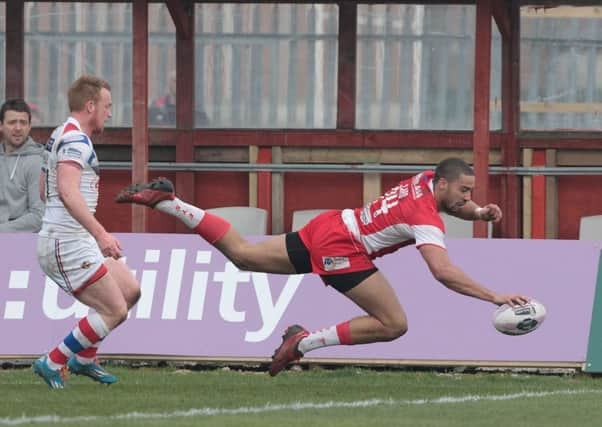 Omari Caro goes over for a try for Hull KR.