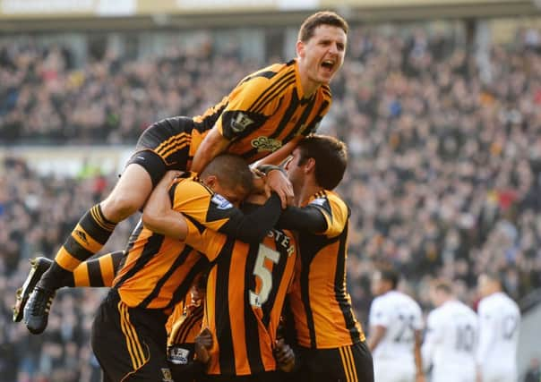 Alex Bruce celebrates a Hull City goal against Manchester United.