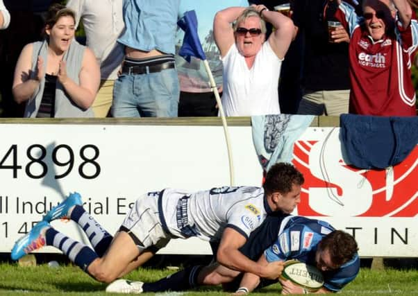 Happy fans watch Michael Keating scoring the Titans' only try.