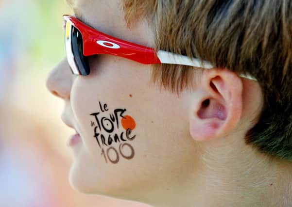 Cycling fan Alex Dale, 11, from Great  Chesterford, waits in the village of  Finchingfield in north Essex for the Tour de France to arrive as it heads from Cambridge into London on stage three of the cycle race. PIC: PA