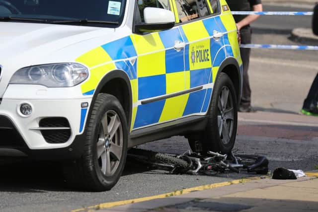 The bike under the wheel of the police car and the recovered firearm. Pictures: Ross Parry Agency