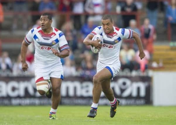 Wakefield's Reece Lyne races away with Ali Lauitiiti in support.