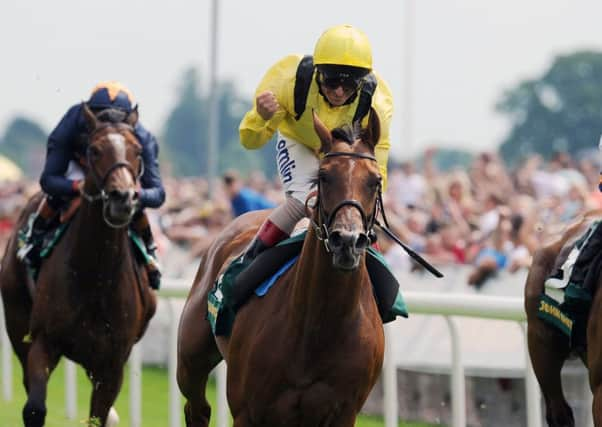 Farraaj, ridden by Andrea Atzeni, celebrates winning the John Smith's Cup.