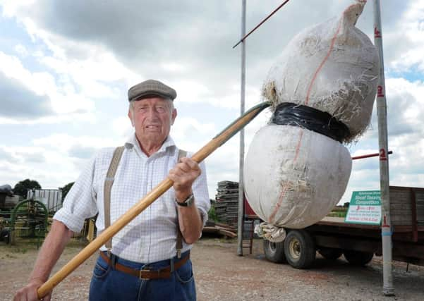 Raising the bar: John Duckitt has been keeping the sport of sheaf tossing alive at the Sykehouse Show.