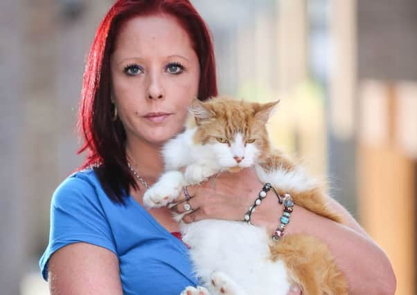 Samantha Davies with Rocky and a note she has posted on her garden gate. Pictures: Ross Parry Agency