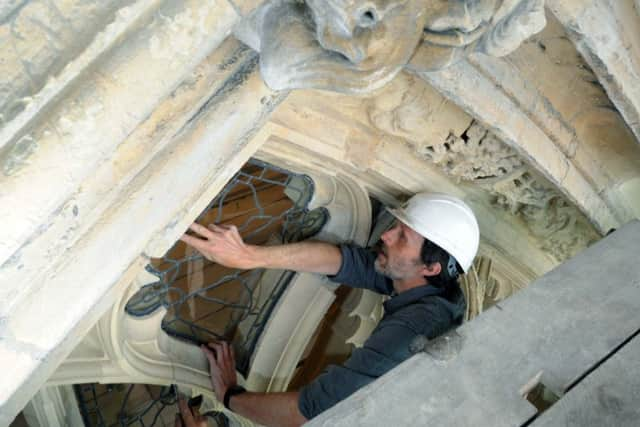 York Glaziers' Trust head glazier Nick Teed installs panels in the Great East Window of York Minster