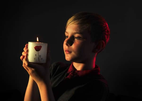 Jay Daniels from Leeds with the Royal British Legion candle to commemotrate the start of World War I.