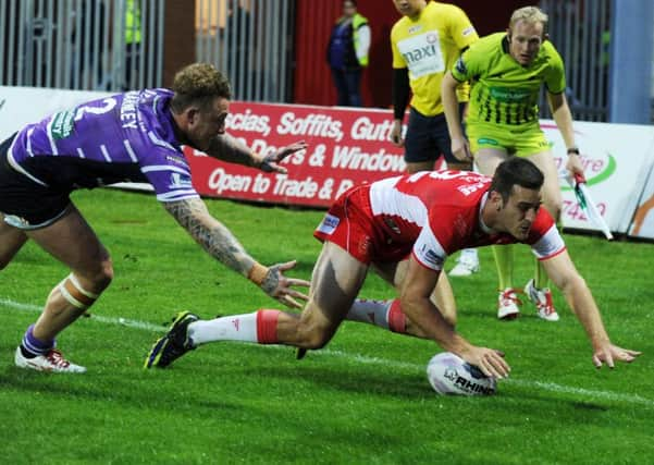 Hull KRs Craig Hall crashes over for a try against Wigan last night but the Warriors battled back to snatch a late point in a 14-14 draw (Picture: Jonathan Gawthorpe).