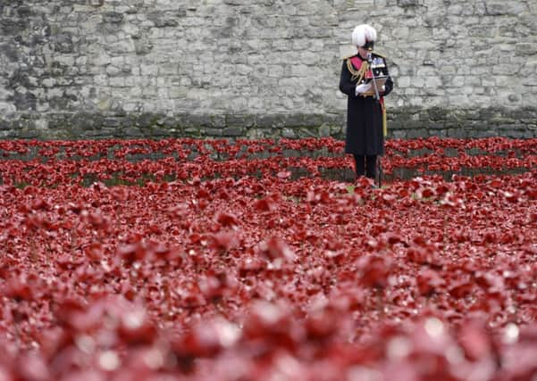 The names of the British and Colonial soldiers who were killed during World War 1 are read out by Lord Dannatt, Constable of the Tower of London amongst the art installation 'Blood Swept Lands and Seas of Red' by artist Paul Cummins at the Tower of London.