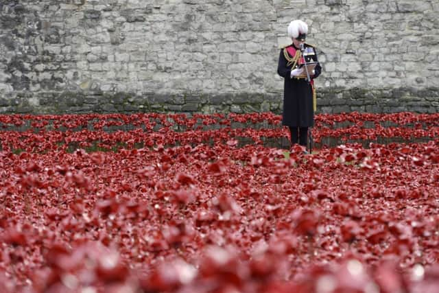 The names of the British and Colonial soldiers who were killed during World War 1 are read out by Lord Dannatt, Constable of the Tower of London amongst the art installation 'Blood Swept Lands and Seas of Red' by artist Paul Cummins at the Tower of London.