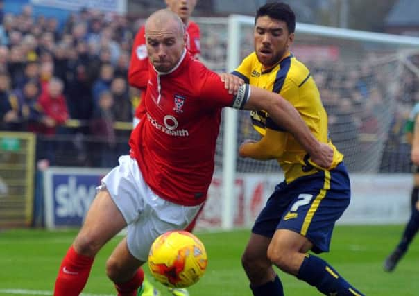 Minstermen captain Russ Penn grapples with U's Danny Rose. (Picture: Tony Johnson)