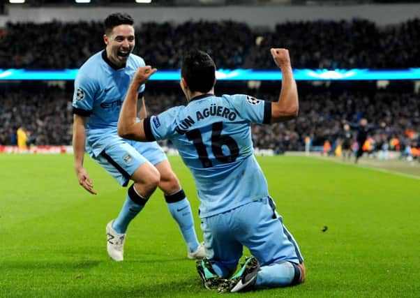 Manchester Citys Samir Nasri races to congratulate team-mate Sergio Aguero after the Argentinian had completed a hat-trick to give his side a 3-2 win over Bayern Munich which keeps alive their hopes of progress in the Champions League (Picture: Tim Goode/AP).