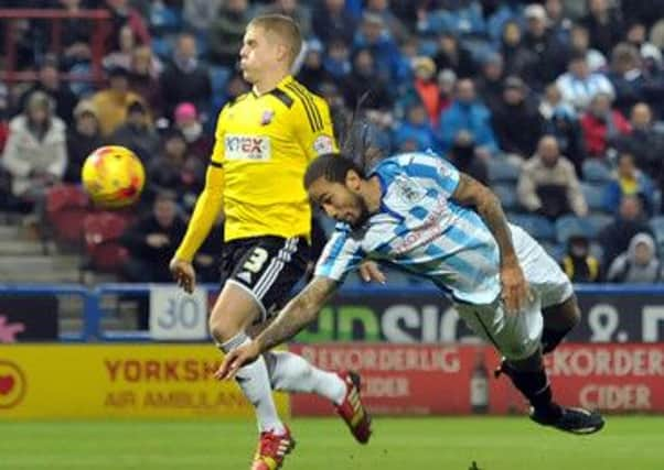 MATCH-WINNER: Sean Scannell'sattempted diving header confuses Jake Bidwell, who can only chest the ball into his own net. Pictures: Graham Crowther.