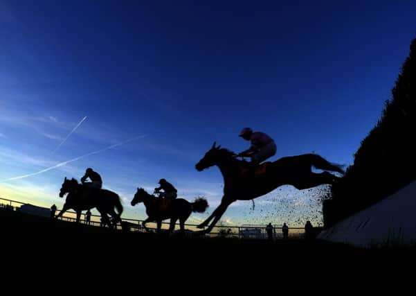 ON TARGET: Dodging Bullets and Sam Twiston-Davies, left, beats Somersby and AP McCoy to win the Tingle Creek Chase at Sandown. Picture: PA