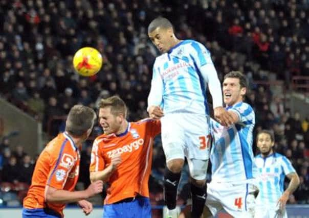 Huddersfield Town's Lee Peltier heads for goal against Birmingham City at the John Smiths Stadium (
Picture: Graham Crowther).