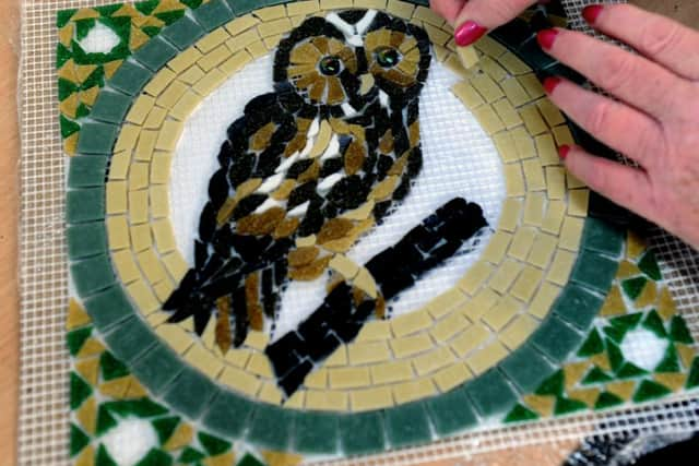 Mosaic artist Frances Taylor in her studio in Otley, surrounded by the tools of her trade and some colourful creations.