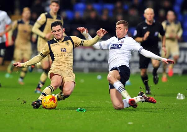 United's Lewis Cook and Trotters' Josh Vela put in a strong challenge.