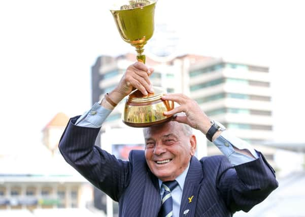 HAPPY DAYS: Yorkshire's club president Dickie Bird celebrates with the County Championship trophy. Picture: Alex Whitehead/SWpix.com