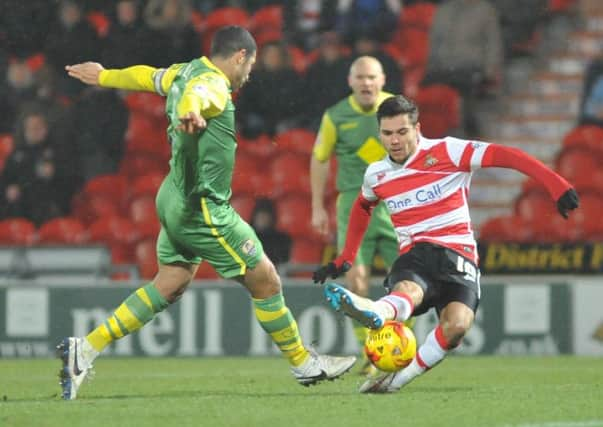 Doncaster Rovers midfielder Harry Forrester tackles Hayden Mullins during last nights match at The Keepmoat (Picture: Steve Uttley).