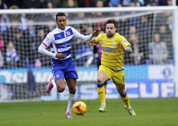 Owls' Chris Maguire with Reading's Jordan Obita.