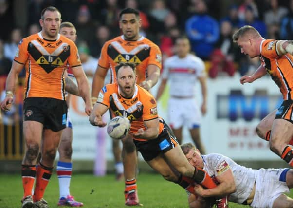 Castleford Tigers' Luke Gale passes under pressure against Wakefield.