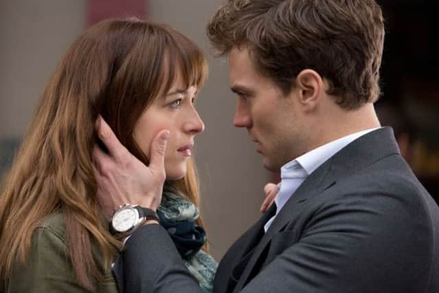 Dakota Johnson as Anastasia "Ana" Steele and Jamie Dornan as Christian Grey.