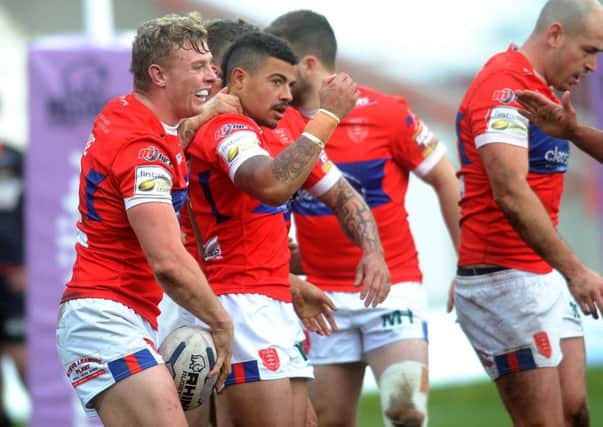 Hull Kingston Rovers' Kieran Dixon (centre) celebrates his winning try against Wigan on Sunday. Picture: Jonathan Gawthorpe.