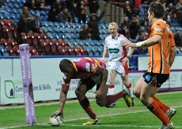 Jermaine McGillvary of Huddersfield Giants scores in the corner