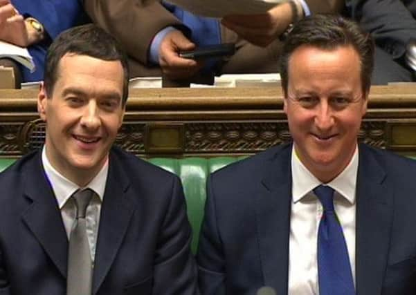 Chancellor of the Exchequer George Osborne and Prime Minister David Cameron listen as Labour leader Ed Miliband responds to the Chancellor's Budget statement