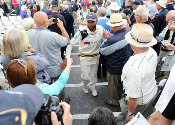 Yorkshire's Adil Rashid is congratulated as the players leave the field after winning the championship. (Picture: Jonathan Gawthorpe).