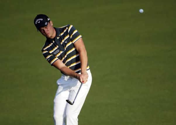 Danny Willett plays his third shot from the first fairway at Augusta yesterday (Picture: Chris Carlson/AP).