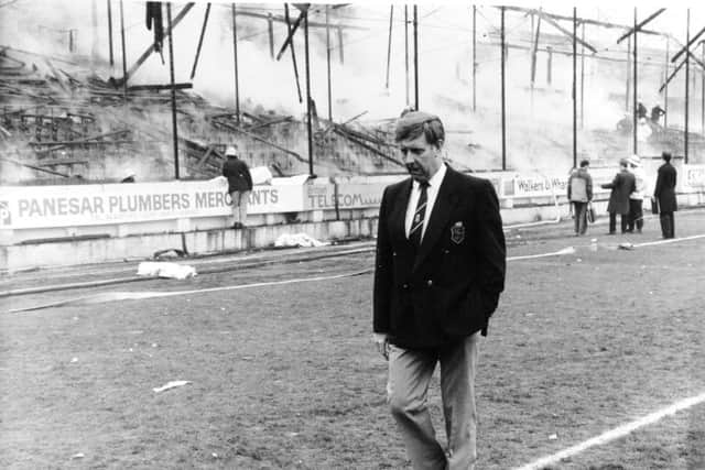 Stafford Heginbotham wanders past the gutted stand where 56 people lost their lives.