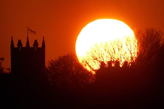 The sun balances next to St Albans Church in Earsdon, North Tyneside