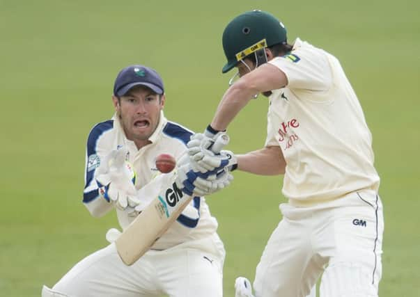 Nottinghamshire's Chris Read plays at a delivery as Yorkshire's Andrew Hodd prepares to take.